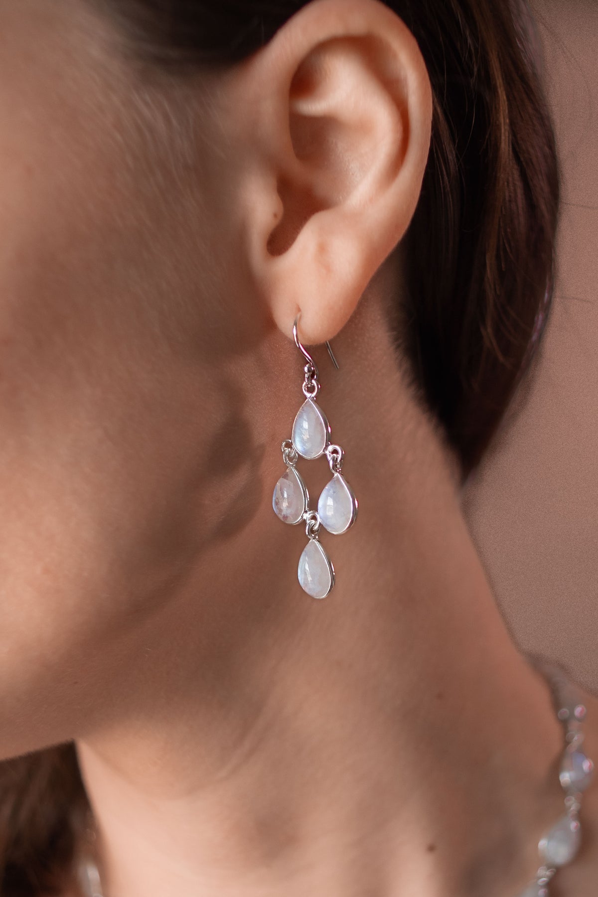 Dew Drops moonstone earrings worn on a model